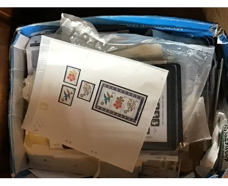A box containing universal Philatelic Auction purchases first day covers and related stamp ephemera.