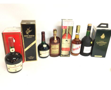 A collection of bottles including Courvoisier, Amaretto, Mandarine Napoleon, Bols Apricot Brandy, three barrels, cognac courv
