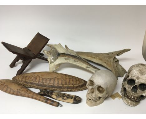 A collection of Aboriginal carved wood small shield and club painted bones a carved hardwood book end and two composition Sku