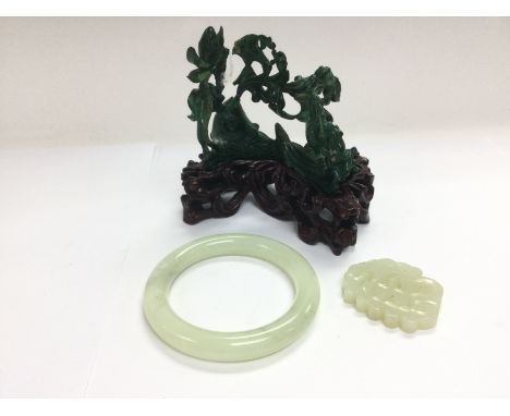 A jade bangle and toggle plus a carved stone ornament. Shipping category B.