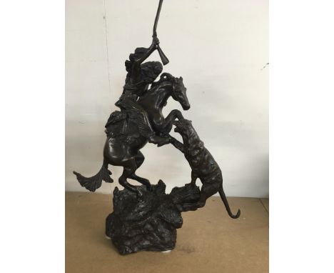 A bronze figure group in the form of a Indian riding a horse after Remington.40 cm