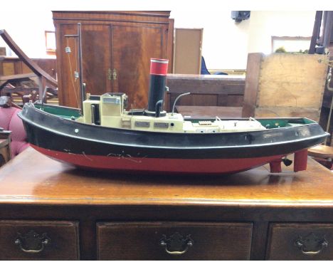 A live steam engine tug boat with boiler. Dimensions 90cm long,23cm wide,44cm tall. This lot cannot. Be posted