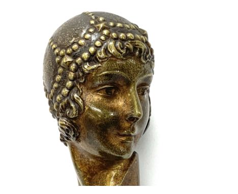 A Small Art Nouveau bronze bust of a lady signed Chiparus mounted on a polished black slate base. (B) some chipping to the sl
