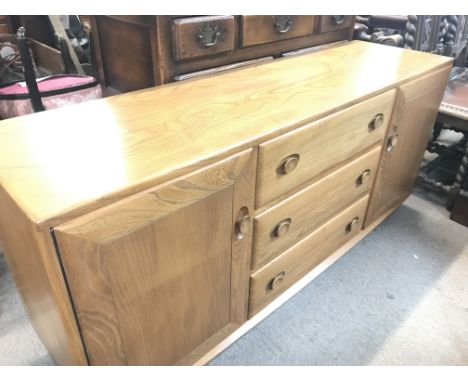 An Ercol sideboard , dimensions 43x155x68cm