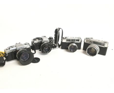 Vintage cameras including an Olympus Om30, Om10, Yashica Minister, Yashica Lynx-14. This lot cannot be posted