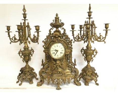 A 20th century Italian ornate bronze clock with candelabra garniture. 60 & 67cm tall. This lot cannot be posted. Some damage