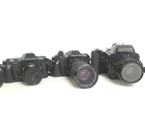 Vintage Pentax cameras including a Pentax 645, and Two Pentax P30 cameras. This lot cannot be posted