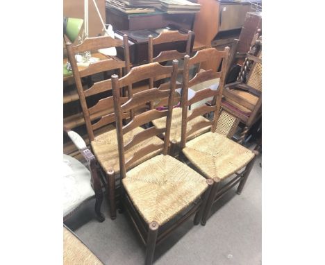 Four 19th century ladder back dining chairs with rush seats. Dimensions 47x38x108cm.