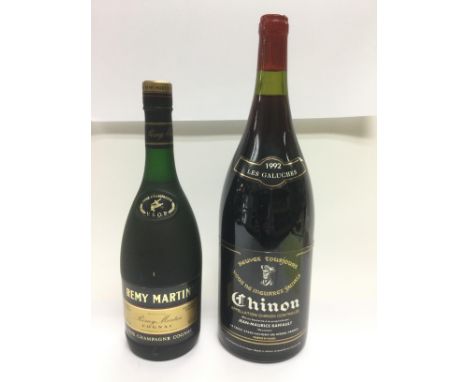 A large bottle of 1992 Chinon red wine and a 70cl bottle of Remy Martin cognac (2). Shipping category D.
