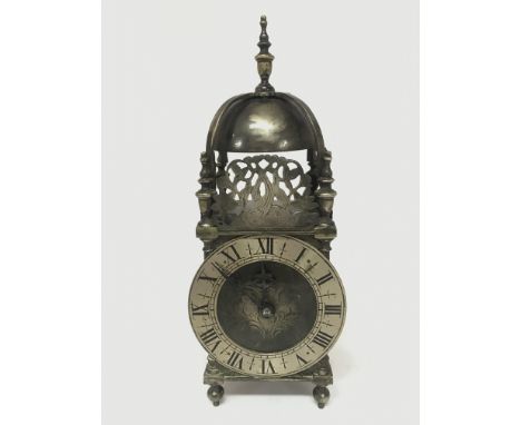 A vintage brass lantern clock with a windup French movement. 31cm tall. Seen working. Postage category C