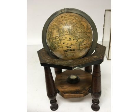 A 19th Terrestrial Globe 4inch set in a measured brass loop and turned wood frame with outer edge paper dial the base with sm