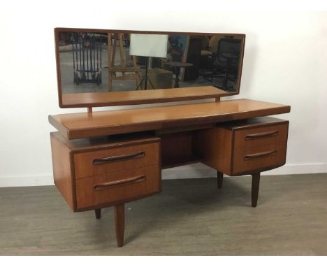 VICTOR WILKINS FOR G-PLAN,a 1960s Fresco teak mirror back dressing table, with arrangement of five drawers and recessed shelf