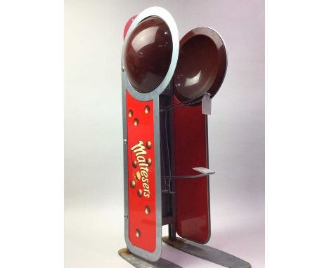 VINTAGE METAL MALTESERS COUNTER PRODUCT HOLDER, on twin metal feet65.4cm high