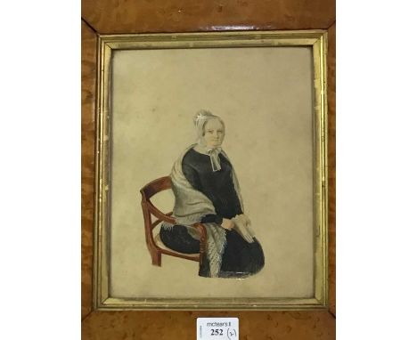 WATERCOLOUR OF A SEATED LADY, EARLY 19TH CENTURY wearing a black dress and white lace cap, signed 'Prout', in a glazed maple 