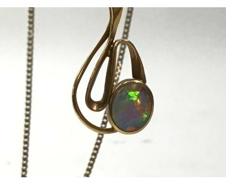 THREE PENDANTS ON CHAINS, comprising an opal example and two others