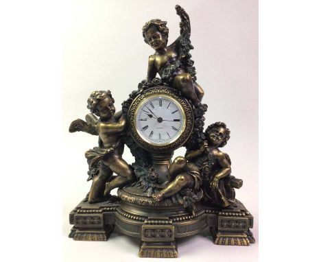REPRODUCTION GILT RESIN MANTEL CLOCK, OF 18TH CENTURY FRENCH DESIGN the circular dial supported by three cherubs34cm high