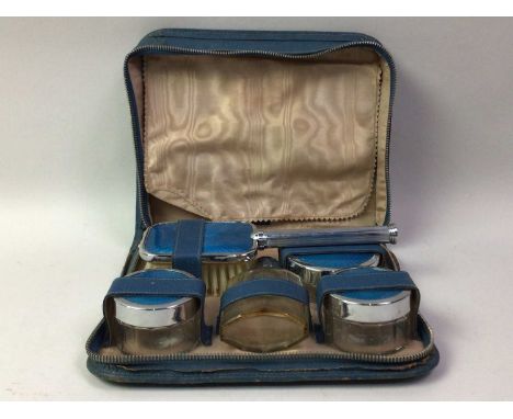 GUILLOCHE ENAMEL WHITE METAL VANITY SET, comprising three jars, a brush, mirror and a perfume bottle, casedStaining, fraying 