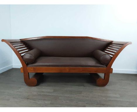 MODERN HARDWOOD CLEOPATRA BENCH, with scroll supports and upholstered in brown vinyl88cm high, 213cm wide