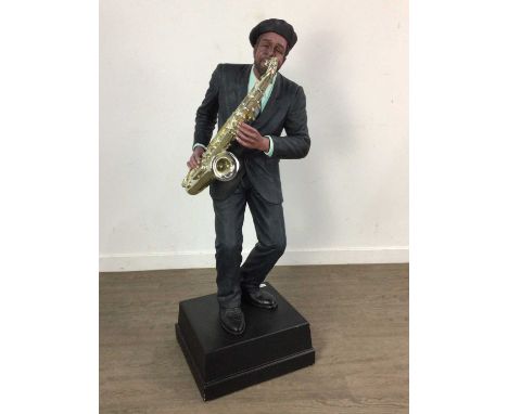 TWO LARGE COMPOSITE FIGURES OF MUSICIANS, comprising one playing a clarinet and the other a saxaphone, each on a square base1
