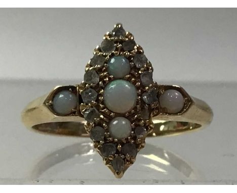 OPAL AND DIAMOND RING, in eighteen carat goldTotal weight is 3.13 grams.general surfaceware, some scratches, some stones are 