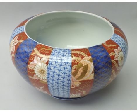 A JAPANESE CERAMIC BOWL, decorated in the Imari taste, bands of cobalt blue on iron red, gilded, with dragon and floral decor