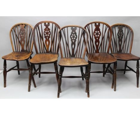 A MATCHED SET OF FIVE PROVINCIAL WHEELBACK SINGLE CHAIRS circa 1900, with shaped elm seats, on ring turned supports with "H" 