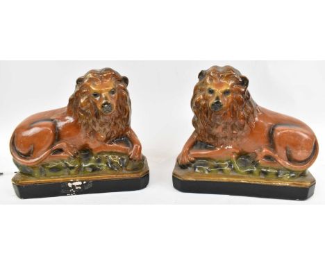 A pair of 19th century Staffordshire stoneware figures of lions, height 25cm.