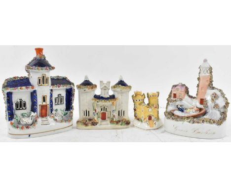 A group of four Staffordshire figures of houses, height of tallest 20cm.