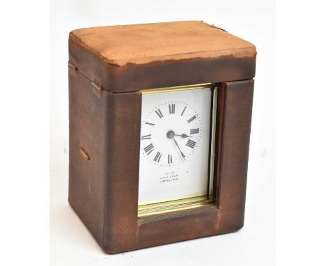 A brass cased carriage clock in leather travelling case.