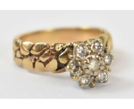A 18ct yellow gold ring set with seven small white stones, size K, approx 3.9g.
