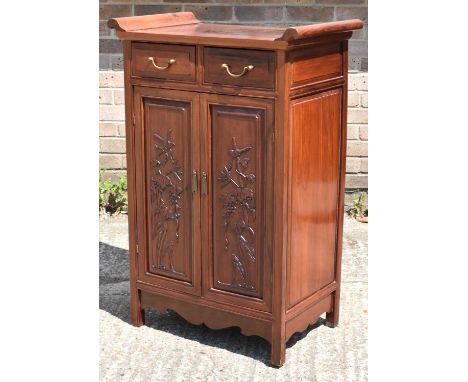 A Chinese hardwood side cabinet with two drawers above pair of doors, width 70cm, height 105cm.