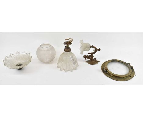 A brass wall light decorated with cherub, a ceiling light with shade, two further glass shades, and a brass ship's porthole (