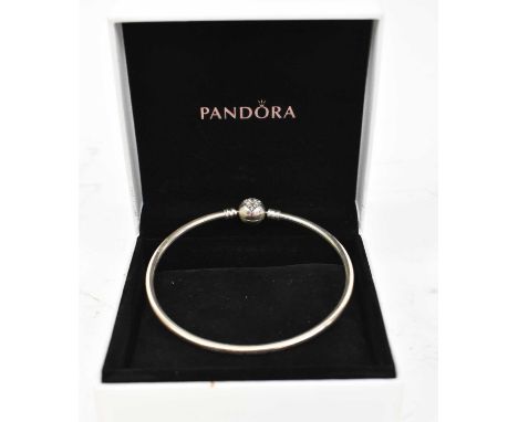 PANDORA; a hallmarked silver lady's bangle with love heart decorated clasp.