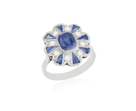 A SAPPHIRE AND DIAMOND RING, centring a cushion-shaped sapphire within collet-setting, to a fancy-cut sapphire and single-cut