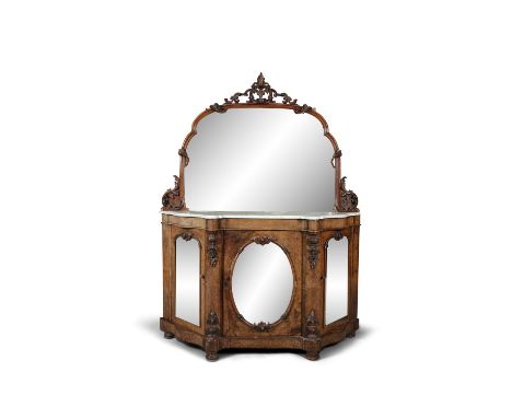 A VICTORIAN WALNUT CREDENZA, the top domed mirrored section surmounted with a pierced carved foliate crest and sides, above a