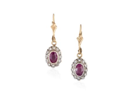 A PAIR OF RUBY AND DIAMOND PENDANT EARRINGS, each earring set with an oval-shaped ruby, within a frame of single-cut diamonds