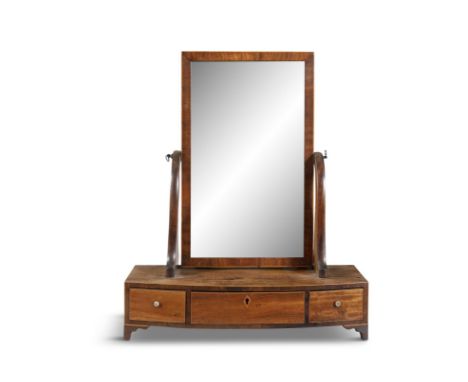 A MAHOGANY CRUTCH FRAME TOILET MIRROR, the rectangular glass plate above a shape base and central and twin side drawers, on b