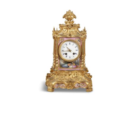 A 19TH CENTURY SMALL FRENCH ORMOLU AND PORECELAIN MANTEL CLOCK, surmounted with stylized finial, above a white enamel dial in