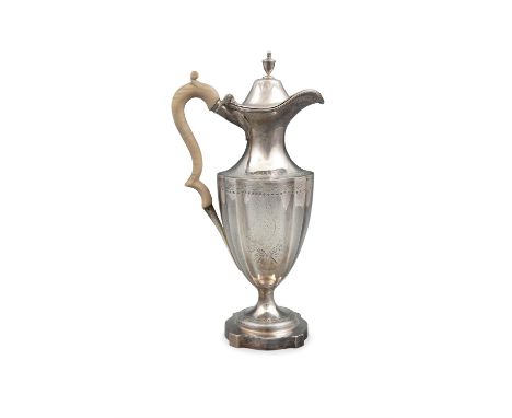 A GEORGE IV SILVER CLARET JUG, London c.1788, mark of 'I K', the fluted body with bright-cut decoration, crested to each side