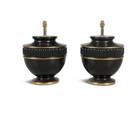 A PAIR OF MODERN BLACK AND GILT CERAMIC TABLE LAMPS, of circular baluster form, with reeded banding and raised on spreading f