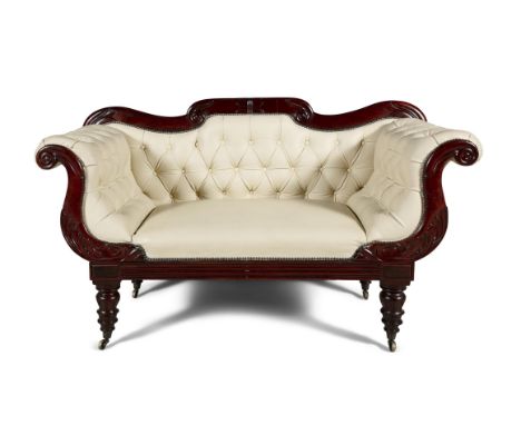 A GEORGE IV MAHOGANY FRAMED SCROLL END BUTTON BACK SETTEE, upholstered in cream leather, raised on turned short supports and 