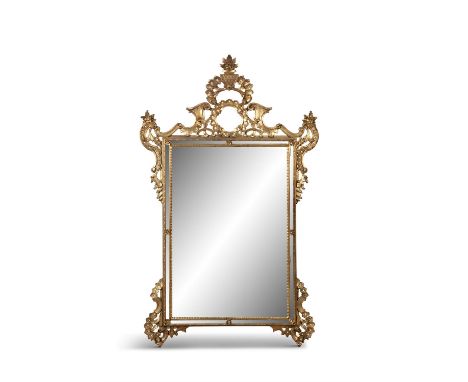 A GEORGIAN STYLE GILTWOOD WALL MIRROR, the rectangular plate surmounted with scrollwork and flower basket, raised on pierced 