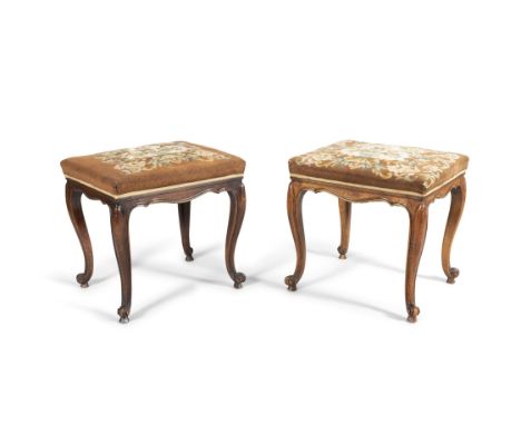 A PAIR OF FRENCH MAHOGANY FRAMED STOOLS, of rectangular form, the stuffed tops covered in brown floral tapestry, raised on ca