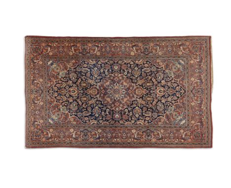 A SEMI-ANTIQUE KASHAN CARPET, of rectangular form, the large centre field woven with a large central medallion against a grou