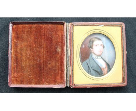 PORTRAIT MINIATURE - a early C19th miniature of a young gentleman painted on Ivory in a leather book frame (65mm x 75mm spine