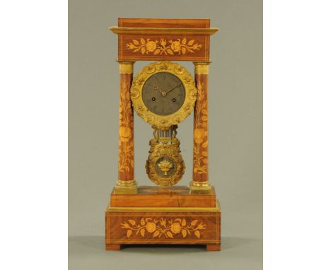 A 19th century continental marquetry portico clock, with two train striking movement.  Height 48 cm, width 23.5 cm, depth 13 