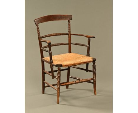 A 19th century Sussex style rush seat armchair, with bobbin turnings.  Height to top of back 88 cm, width across arms 61 cm. 