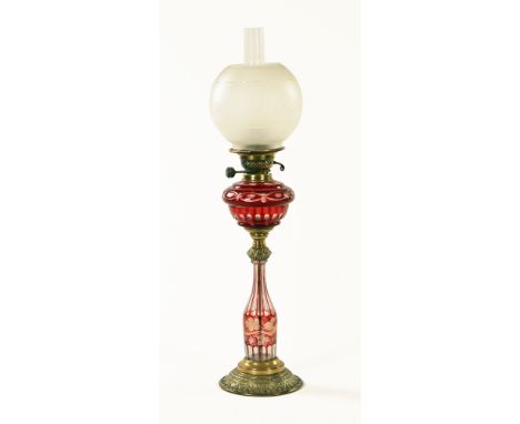 A 19th century cranberry glass brass and glass paraffin lamp, with globe shade.  Height 74 cm. CONDITION REPORT: The shade is