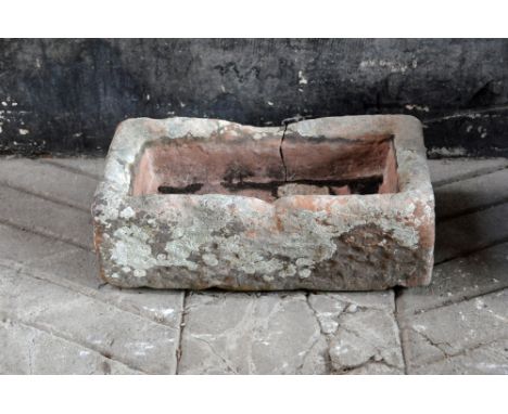 A rectangular sandstone trough.  Height +/- 21 cm, width 64 cm, depth 35 cm.