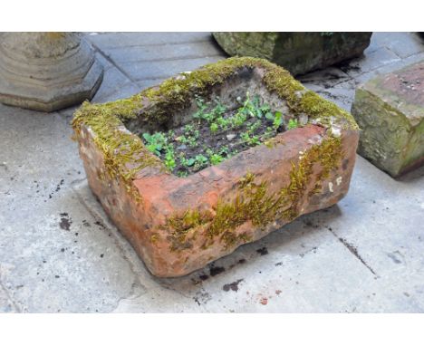 A rectangular sandstone trough.  Height 28 cm, width 63 cm, depth 46 cm.